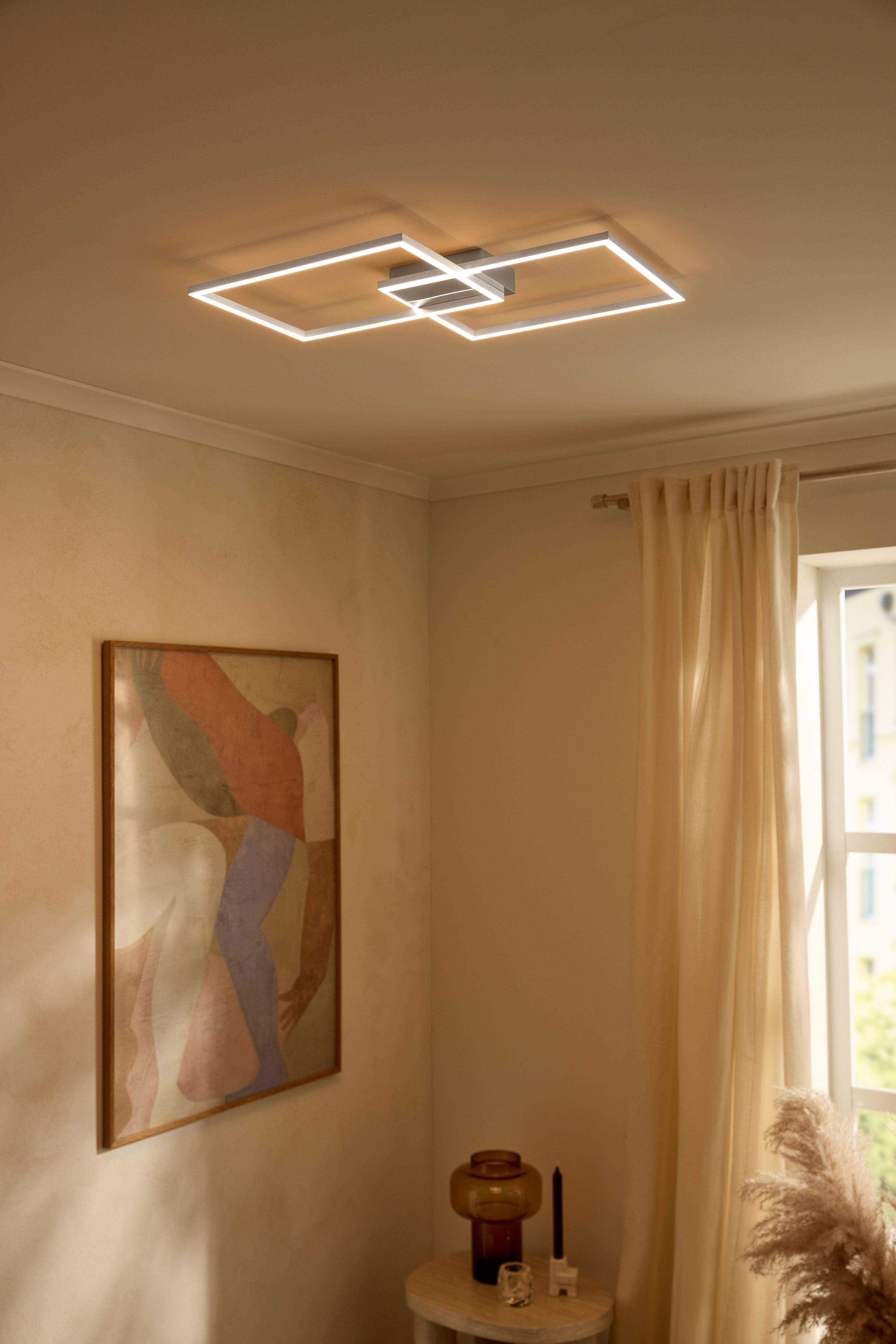 Modernus LED lubinis šviestuvas stačiakampių formos, apšviečiantis smėlio spalvos kambarį.